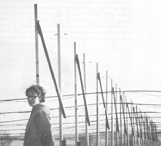 Bel Burnell standing in front of what looks like a large clothes line