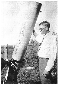 Clyde Tombaugh (at age 22) shown with his homebuilt 9-inch reflecting telescope